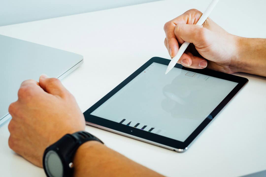 Person using a stylus on a tablet