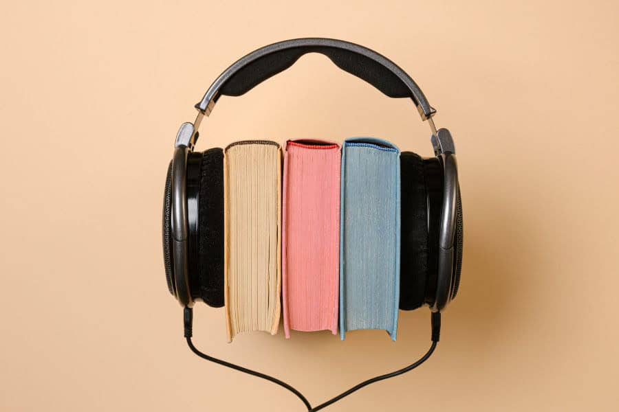 Headphones around three books