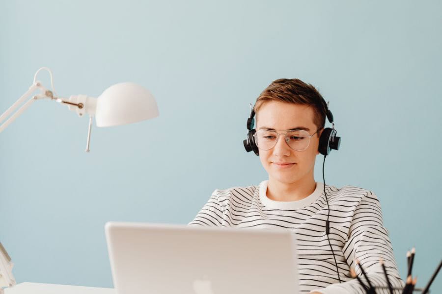 Person with headphones using a laptop