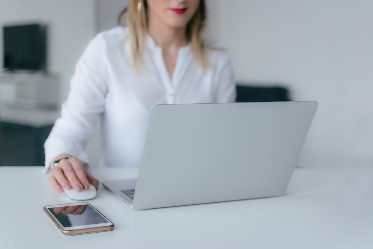 woman using a silver laptop